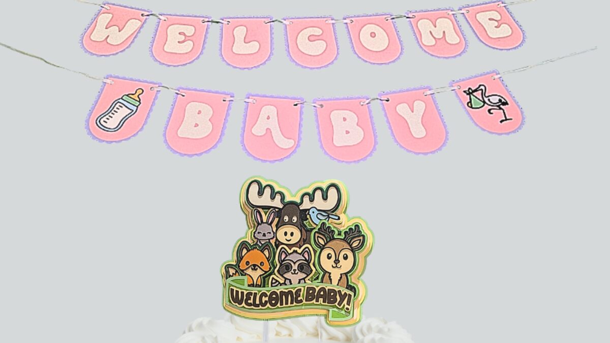 Welcome Baby banner with a woodland animal cake topper